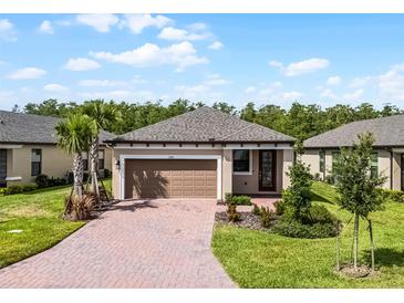 Charming single-story home with a paver driveway and two-car garage at 1388 Lombardi Ct, Kissimmee, FL 34759
