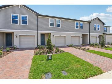 Attractive townhomes boast well-maintained landscaping and brick driveways for enhanced curb appeal at 16390 Bird Of Paradise Ave, Clermont, FL 34714