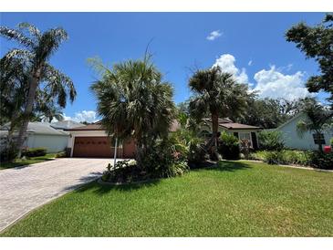 Charming single-story home features lush landscaping and a well-maintained lawn at 3807 Plantation Blvd, Leesburg, FL 34748