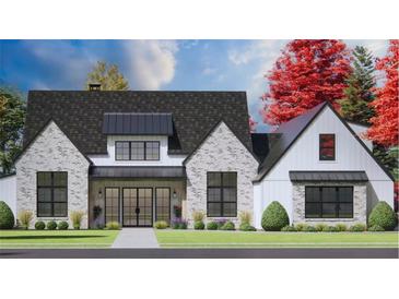 Charming two-story home with gray brick, black framed windows, manicured lawn and beautifully landscaped front yard at 4343 Juliana Lake Dr, Auburndale, FL 33823