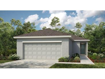Charming single-story home featuring a large garage and well-maintained landscaping at 7412 Sandstone Dr, Groveland, FL 34736