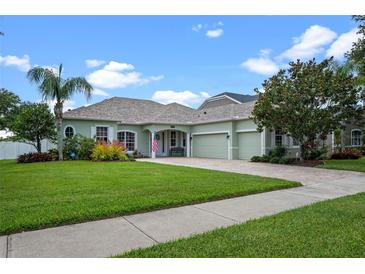 Charming single-story home with a well-manicured lawn, a brick driveway, and inviting curb appeal at 13838 Bluebird Park Rd, Windermere, FL 34786