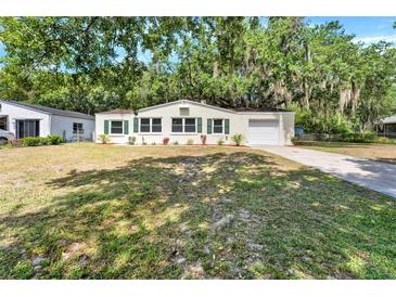 Charming single-story home with a well-maintained lawn, green shutters, and a one-car garage at 1506 S Elliott St, Sanford, FL 32771