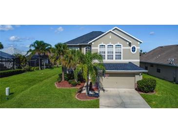 Two-story home with well-manicured lawn, front yard landscaping, and a two-car garage at 2530 The Oaks Blvd, Kissimmee, FL 34746