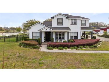 Charming two-story home with landscaped yard and elegant monochrome color palette at 3201 Dallas Blvd, Orlando, FL 32833