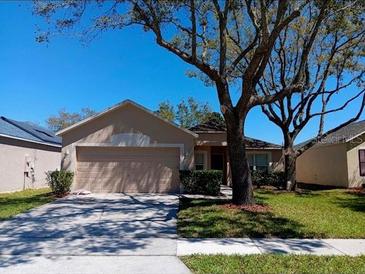 Charming single-story home with a well-maintained lawn and mature trees at 3530 Stonefield Dr, Orlando, FL 32826