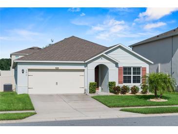 Charming single Gathering home with a well-manicured lawn and a two-car garage at 3817 Heartleaf Ln, Mount Dora, FL 32757