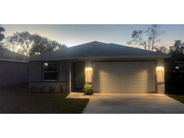 Charming single-story home features a two-car garage and well-manicured lawn in a desirable neighborhood at 534 S Adelle Ave, Deland, FL 32720