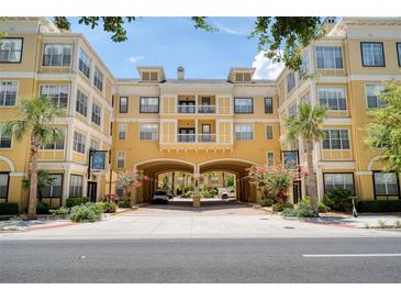 Beautiful multi-story building with a grand entryway and lush landscaping at 860 N Orange Ave # 210, Orlando, FL 32801