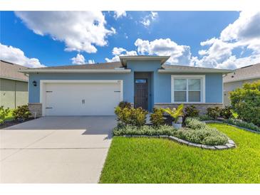 Charming single-story home featuring a well-manicured lawn, attached garage, and delightful curb appeal at 633 Greymount St, Davenport, FL 33837