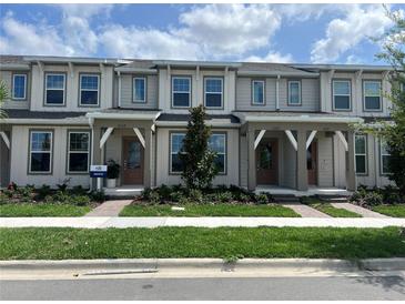 Charming townhome featuring a well-manicured lawn and inviting front porches, perfect for relaxing outdoors at 6331 Breeze Filled Ln, Winter Garden, FL 34787