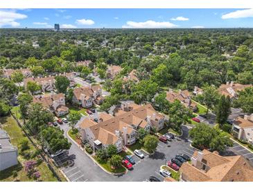An aerial view of a residential community with lush green trees and well-maintained townhomes at 645 Stafford Ter # 163, Altamonte Springs, FL 32714