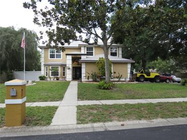 Charming two-story home features manicured lawn, mature trees, and a welcoming front entrance at 1420 Center St, Ocoee, FL 34761