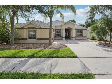 Charming single-story home with a well-manicured lawn and a large driveway leading to the front entrance at 2315 Black Lake Blvd, Winter Garden, FL 34787