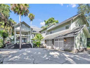 Stunning two-story home featuring a three-car garage and inviting front entry with well-manicured landscaping at 419 Whitcomb Dr, Geneva, FL 32732