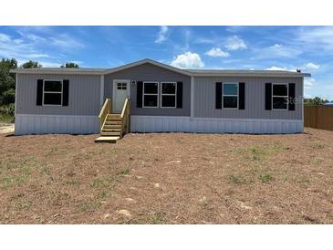 Charming single-story home featuring a neutral color scheme and black window shutters at 4720 Oak St, Fruitland Park, FL 34731