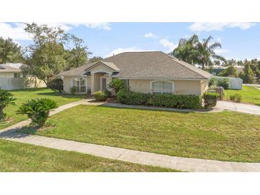 Charming single-story home with a well-manicured lawn and mature landscaping at 710 Independence Dr, Orange City, FL 32763