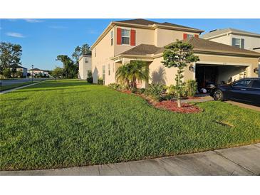 Well maintained two-story home featuring a lush green lawn and manicured landscaping at 1259 Pando Loop, Orlando, FL 32824