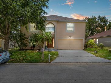 Charming two-story home features lush landscaping and a large two-car garage at 1905 Emily Blvd, Winter Haven, FL 33884