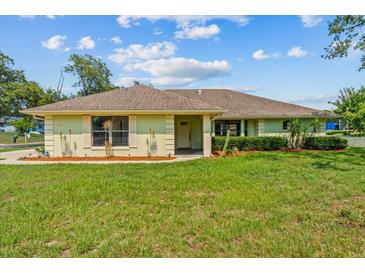 Charming one-story home featuring a well-manicured lawn and a welcoming front porch at 2351 El Prado Ter, Deltona, FL 32725