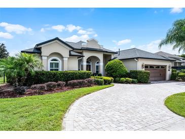 Well-maintained home with manicured lawn, paver driveway, and lush landscaping at 5740 Aloma Woods Blvd, Oviedo, FL 32765
