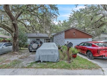 Charming single-Gathering home featuring stone accents and a well-maintained front yard at 10359 Smyrna Dr, Orlando, FL 32817