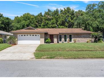 Charming single-story home featuring a two-car garage and well-manicured lawn at 2151 Conifer Ave, Winter Park, FL 32792