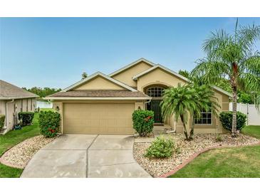 Charming single-story home with a well-manicured lawn and inviting curb appeal with tropical landscaping at 2360 Brewerton Ln, Orlando, FL 32824