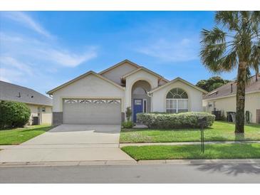 Charming single-story home with attached garage and well-manicured front lawn at 2515 La Jolla Trl, Kissimmee, FL 34747