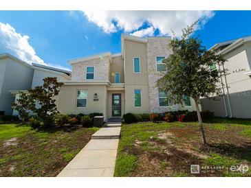 Charming two-story home boasting modern architectural design, manicured landscaping, and a welcoming entrance at 2816 Simile St, Kissimmee, FL 34746