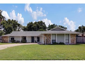 Charming single-story home boasts stone accents and a well-manicured front lawn at 4217 Ilene Ct, Orlando, FL 32806