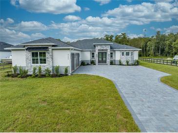Stunning single-story home with manicured lawn and elegant stone accents at 4266 La Salle Ave, St Cloud, FL 34772