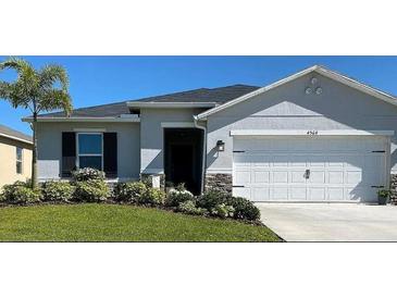 Charming single-story home featuring a well-manicured lawn and a two-car garage in a lovely neighborhood at 4564 Orchard Grove Rd, St Cloud, FL 34772