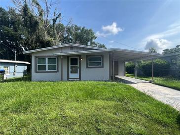 Cozy single-story home featuring a carport and a well-maintained front yard and walkway at 4631 America St, Orlando, FL 32811
