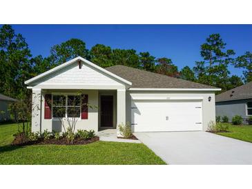 Charming single-Gathering home featuring an attached two-car garage and a well-manicured lawn at 1055 Morfontain St, Daytona Beach, FL 32124