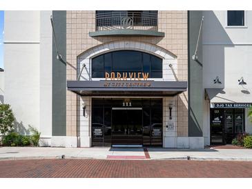 Elegant building entrance featuring detailed stonework, glass doors, and a welcoming design at 111 E Monument Ave # 801, Kissimmee, FL 34741