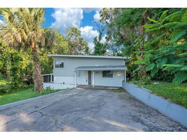 Charming two-story home featuring a modern design, complemented by lush tropical landscaping and a private driveway at 1630 Lakeview Ct, Eustis, FL 32726