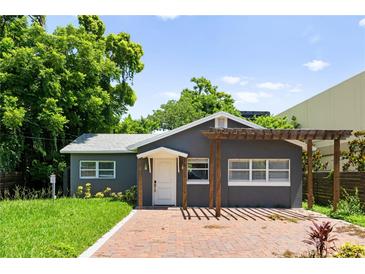 Charming home featuring a gray exterior, brick walkway, and pergola at 1921 Dartmouth Ave, Winter Park, FL 32789