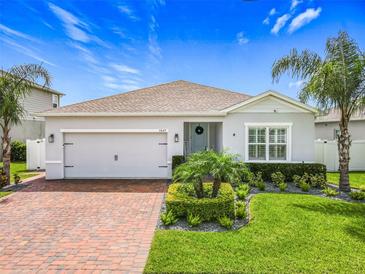 Charming single-story home with brick driveway, manicured lawn and meticulously designed tropical landscaping at 3849 Kimbolton Way, Sanford, FL 32773