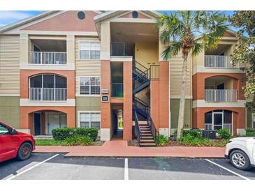 Condo exterior features balconies, stairwell, and colorful facade at 1950 Summer Club Dr # 200, Oviedo, FL 32765