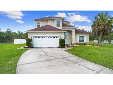 Charming two-story home with a well-manicured lawn and a spacious driveway at 412 Mallard Way, Kissimmee, FL 34759