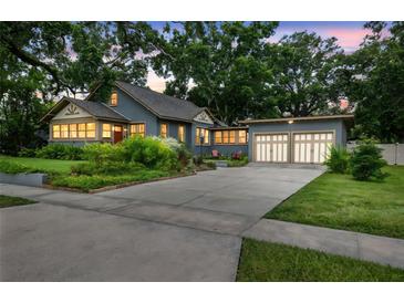Charming home with well-manicured lawn, mature trees, and a two-car garage at 524 S Lakeview Ave, Winter Garden, FL 34787