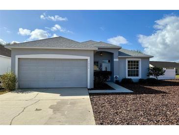 Charming single-Gathering home with a well-maintained lawn and two-car garage in a suburban neighborhood at 1354 Knollwood Dr, Davenport, FL 33837