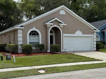 Charming single-story home featuring manicured lawn and attached two car garage at 2131 Kaylas Ct, Orlando, FL 32817