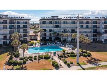 Beautiful pool and common area surrounded by lush landscaping at beachfront condo buildings at 2700 Ocean Shore Blvd # 515, Ormond Beach, FL 32176