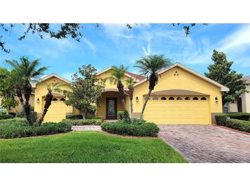 Welcoming single Gathering home boasts a two car garage, well manicured lawn and lush landscaping at 340 Sorrento Rd, Kissimmee, FL 34759