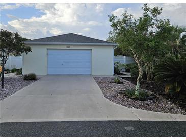 Charming single-story home with a one-car garage and meticulous landscaping at 1008 Jackson St, The Villages, FL 32162