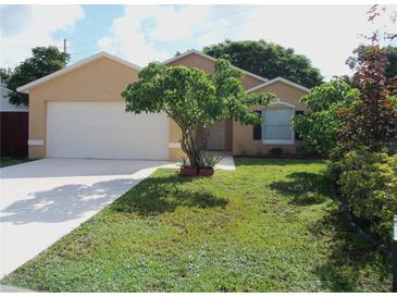 Charming single-story home with a well-manicured lawn, mature landscaping, and a two-car garage at 1021 Golfside Ct, Kissimmee, FL 34741