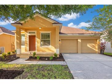 Charming single-story home featuring a two-car garage and well-manicured front yard at 10580 Moss Rose Way, Orlando, FL 32832