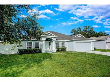 Charming single-story home with well-manicured lawn and inviting front entrance at 1373 Burnley Ct, Kissimmee, FL 34758